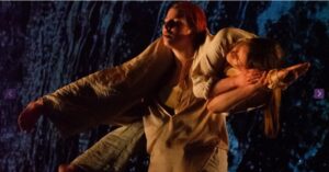 Two dancers reach out